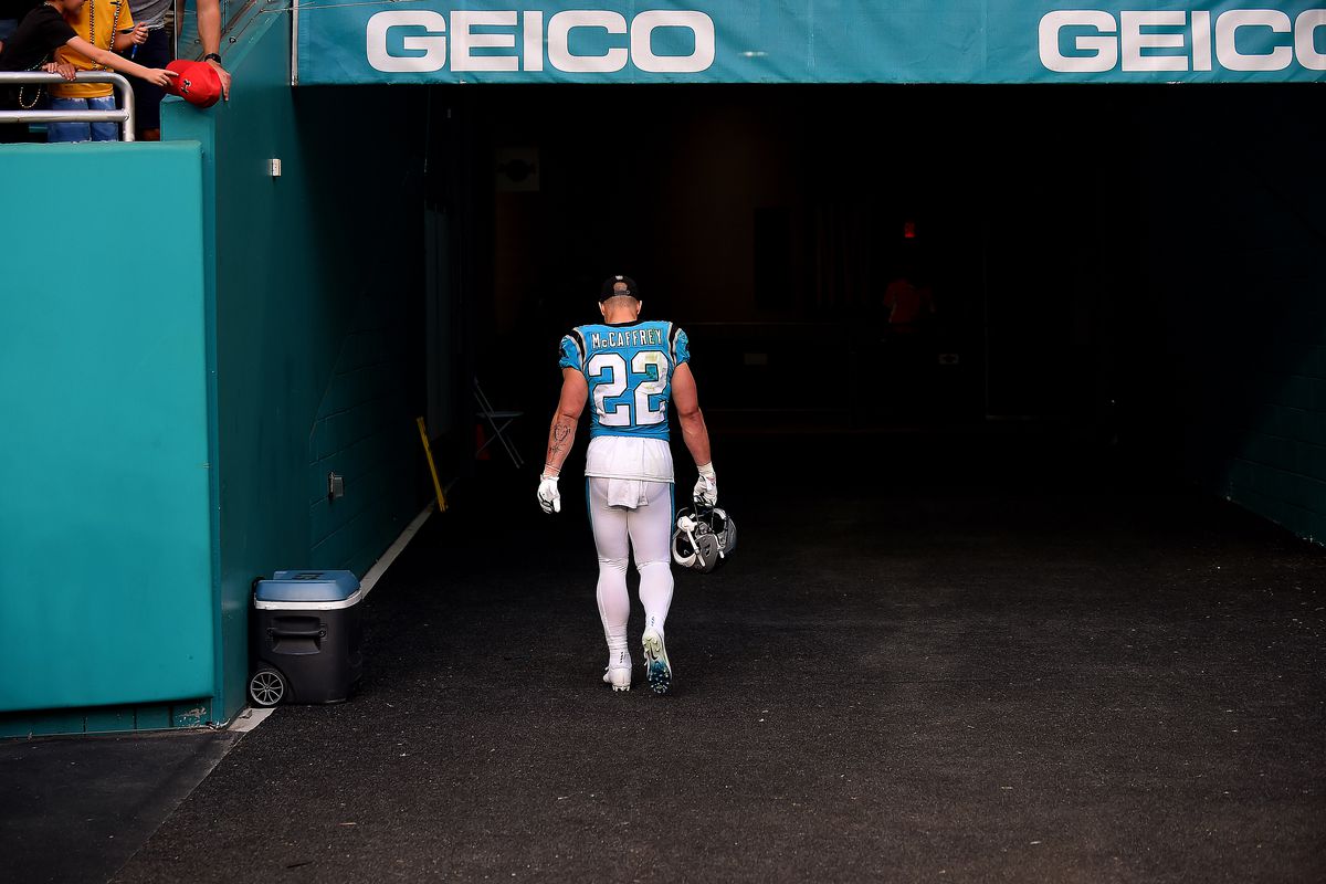 Christian McCaffrey #22 of the Carolina Panthers walks back to the locker room after Carolina was defeated by Miami 33-10 at Hard Rock Stadium on November 28, 2021 in Miami Gardens, Florida.