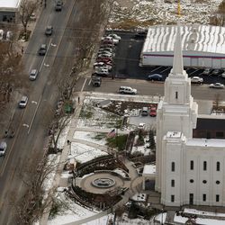 The funeral procession for Utah Highway Patrol trooper Eric Ellsworth travels past the Brigham City Utah Temple on its way to the Brigham City Cemetery on Wednesday, Nov. 30, 2016.