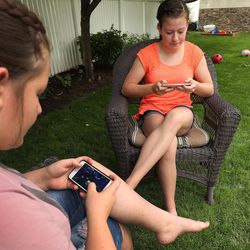 Morgan Selleneit, right,  plays Fornite with her friend Macee Silvester at her home in Centerville on Thursday, May 31, 2018. Morgan is 15 and uses her phone around 3 hours a day, mostly on Instagram and Snapchat.