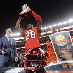 Utah Utes running back Joe Williams (28) holds up his offensive player of the game award as the Utes defeat the Hoosiers in the Foster Farms Bowl in Santa Clara, California, on Wednesday, Dec. 28, 2016.