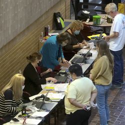 Citizens register to vote in person at the Salt Lake County Government Center during the first day of early voting in Utah on Tuesday, Oct. 20, 2020.