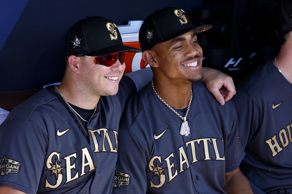Ty France #23 and Julio Rodriguez #44 of the Seattle Mariners smile in the dugout before the 92nd MLB All-Star Game presented by Mastercard at Dodger Stadium on July 19, 2022 in Los Angeles, California.