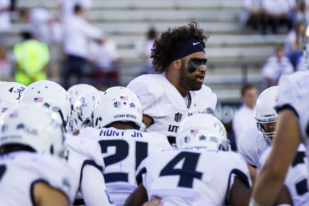 Utah State senior defensive end Ricky Ali'ifua (center) fires up his team prior to the Aggies' game against Arkansas State earlier this season.