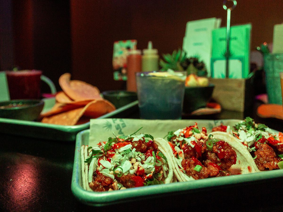 Three tacos on a platter.