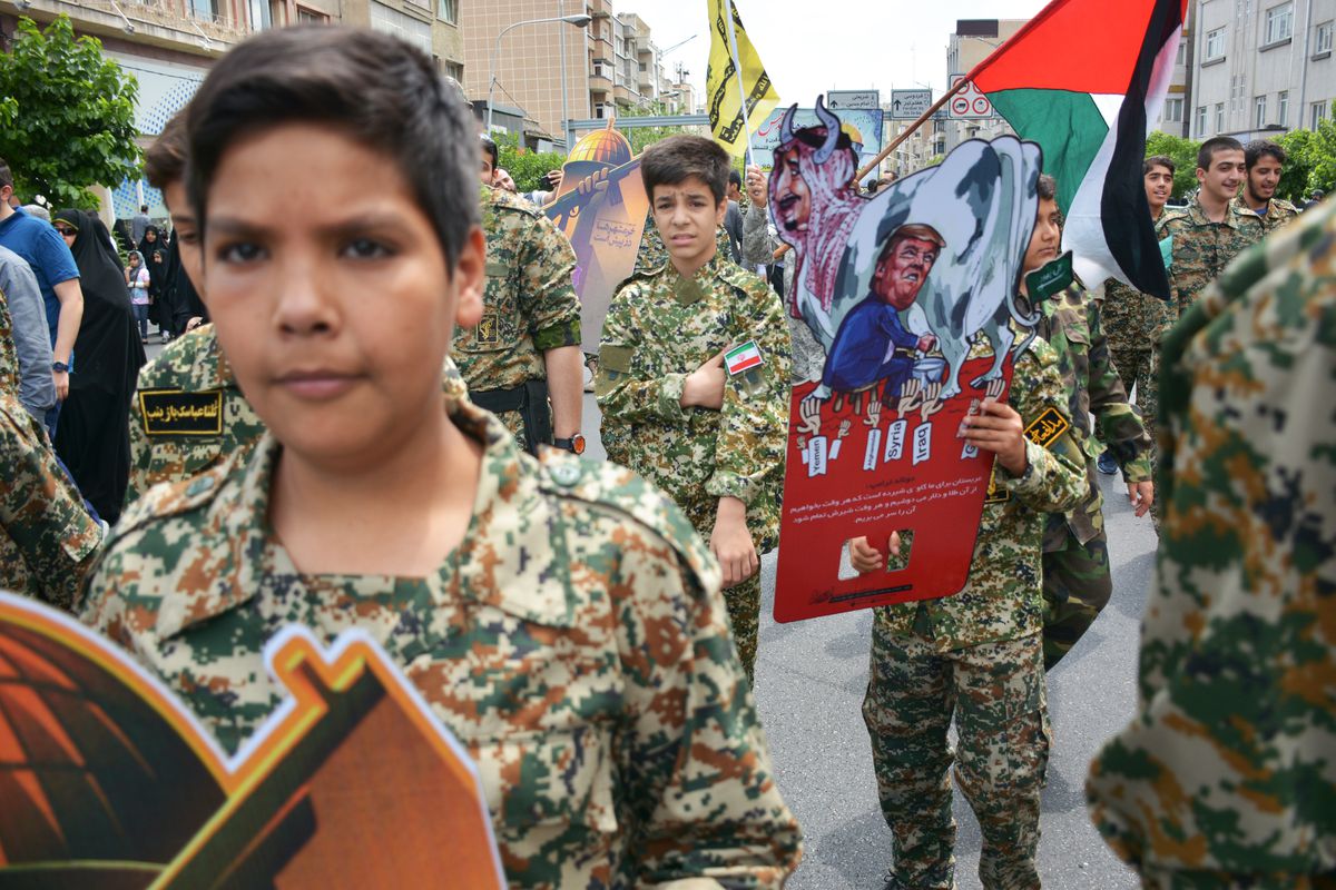 Young members of Iran’s Basij paramilitary force rally in Tehran. One holds a Trump sign.