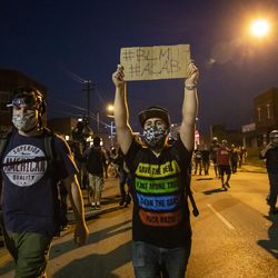 Protesters peacefully march around Kenosha on the fourth day of civil unrest after police shot Jacob Blake, Wednesday night, Aug. 26, 2020.