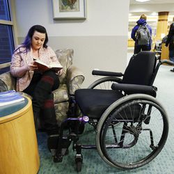 Stacy Davis-Stanford reads at Westminster College where she is a student in Salt Lake City Thursday, Feb. 26, 2015  Davis-Stanford lacks health insurance and has a neurological disorder resulting from a car accident.  