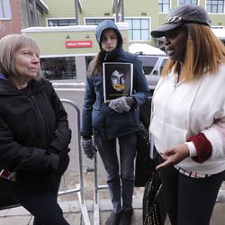 Brenda Jenkins and Morgan Steffen, who are protesting "Leaving Neverland," a documentary about Michael Jackson, talk to Geraldine Hughes, the author of "Redemption: The Truth Behind the Michael Jackson Child Molestation Allegations," outside of the Egyptian Theatre during the Sundance Film Festival in Park City on Friday, Jan. 25, 2019.
