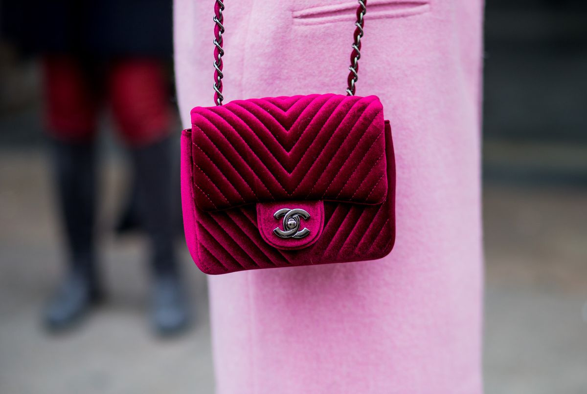 A close up of a pink Chanel bag and pink coat