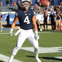 Brigham Young Cougars running back Lopini Katoa (4) celebrates a touchdown  in Provo on Saturday, Sept. 22, 2018.