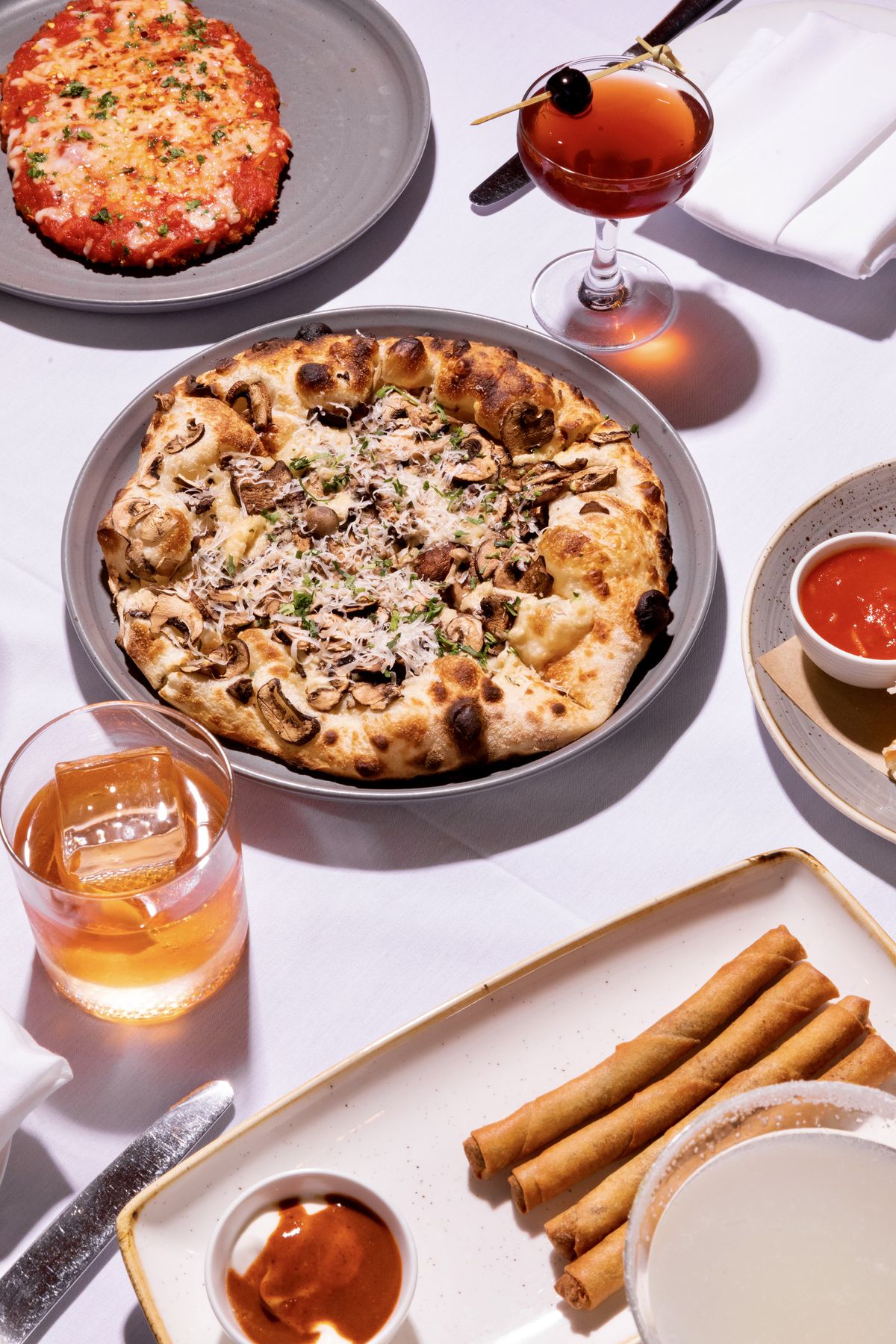 A full pizza, two side dishes and cocktails.