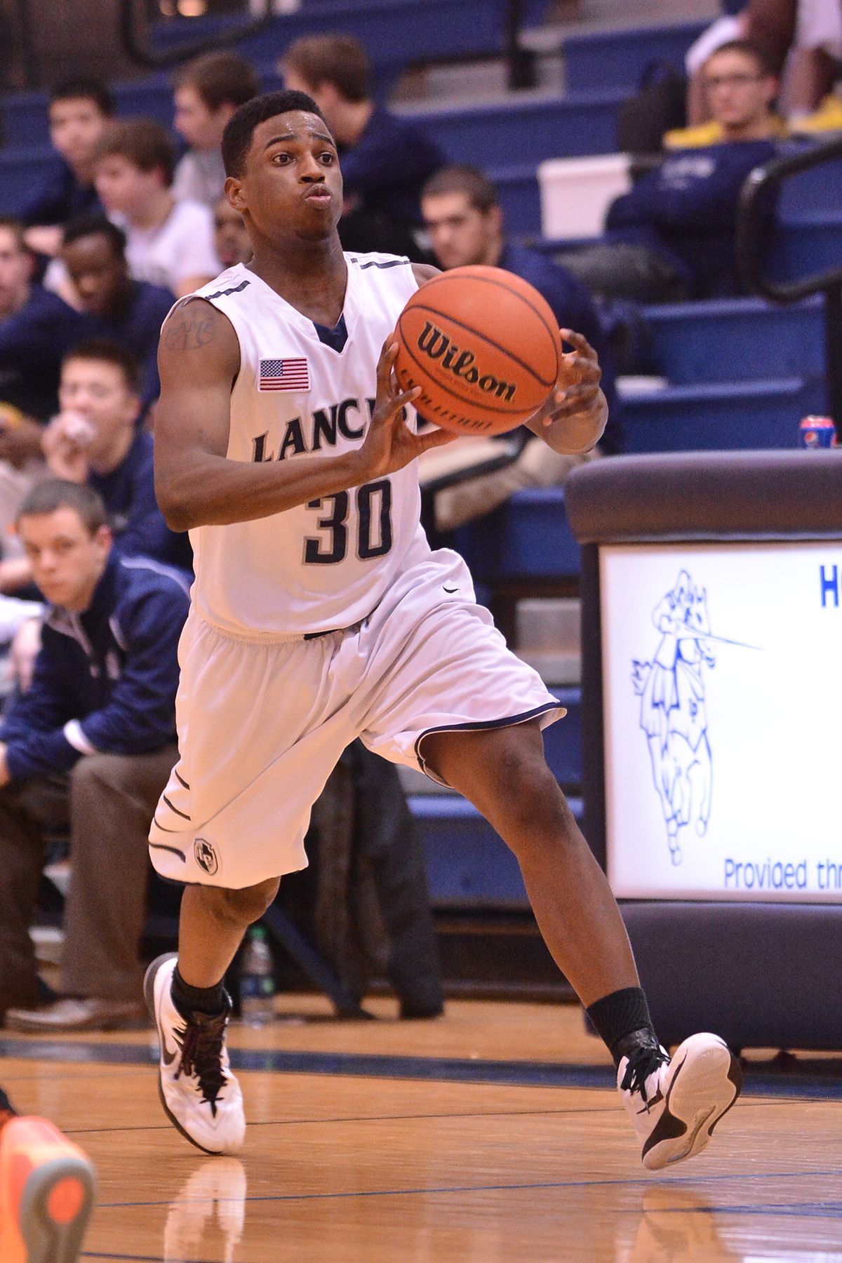 Lake Park's Marcus McDaniel (30) passes the ball up court against Wheaton-Warrenville South.