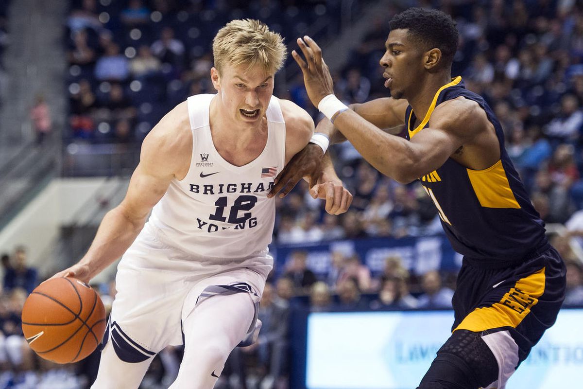 Brigham Young forward Eric Mika (12) drives to the hoop against Coppin State forward Izais Hicks (11) during an NCAA college basketball game in Provo on Thursday, Nov. 17, 2016. 