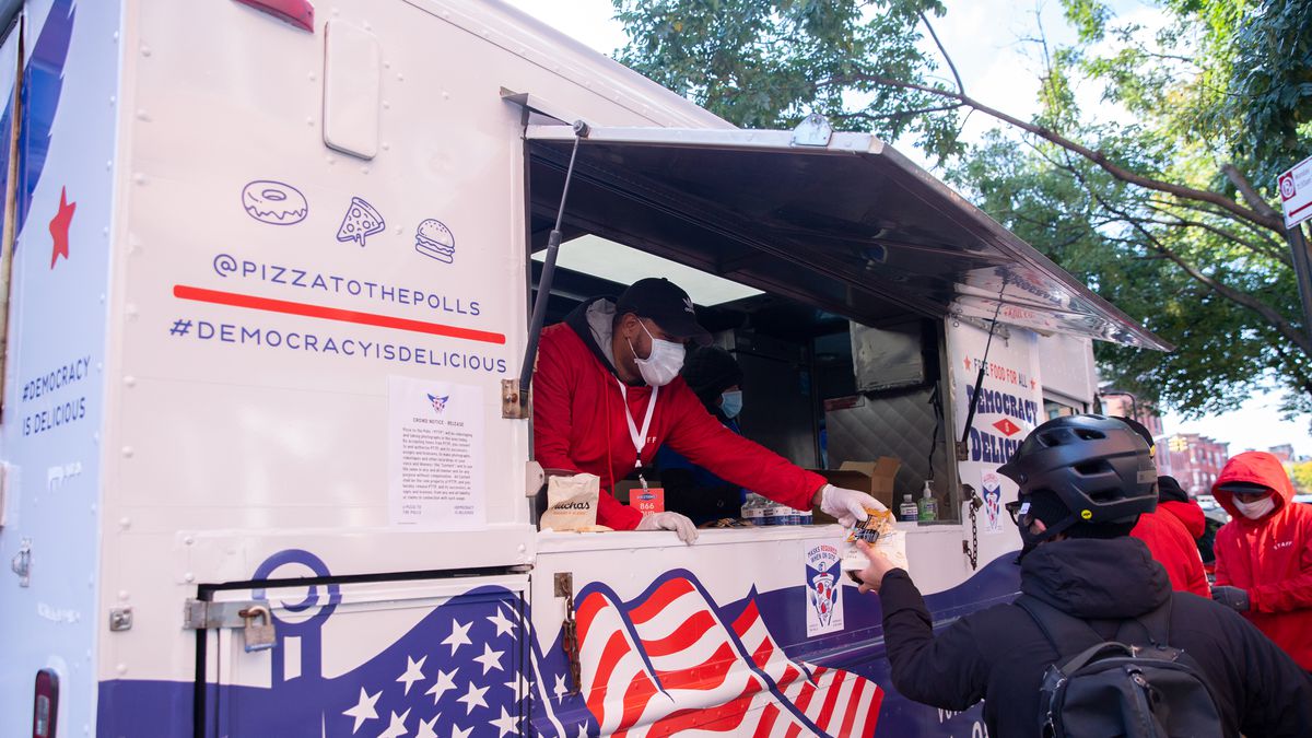 Food truck workers give away free meals during early voting outside the Park Slope Armory, Oct. 31, 2020.