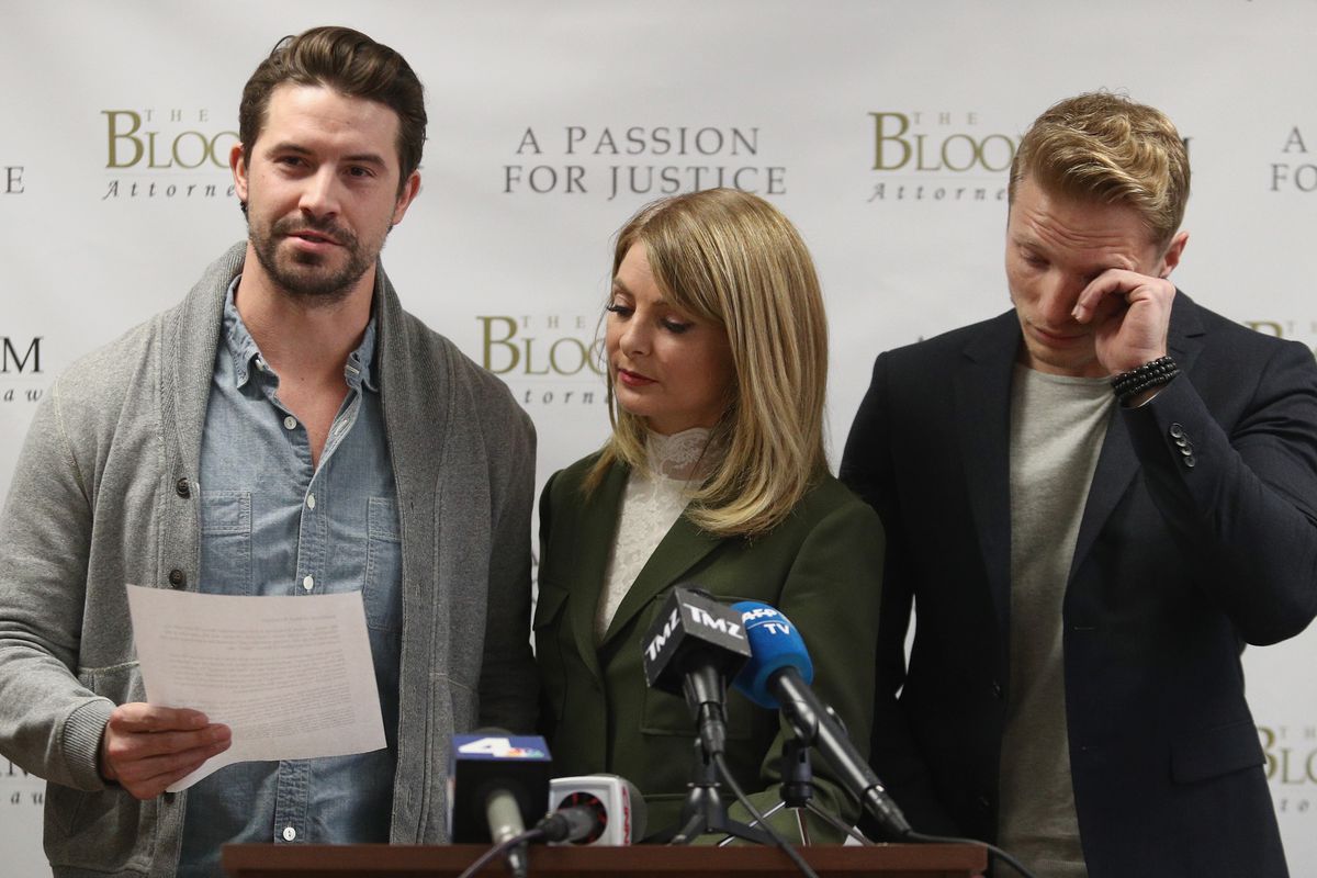 Model Mark Ricketson (l) reads a statement at The Bloom Firm accusing photographer Bruce Weber of sexual misconduct. Attorney Lisa Bloom and former model Jason Boyce stand beside him.