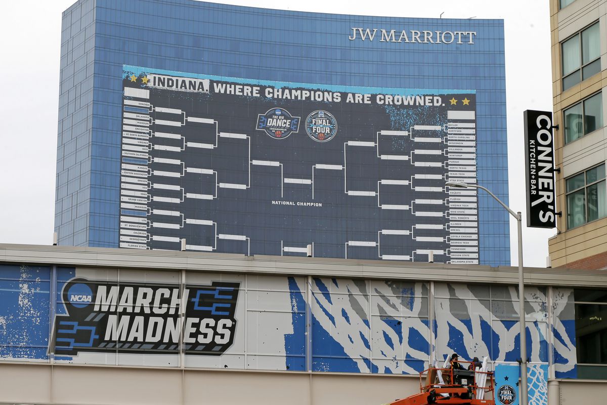 A giant banner showing the tournament bracket hangs from the J.W. Marriott hotel as Indianapolis prepares to host the 2021 NCAA Division I Basketball Tournament on Wednesday, March 17, 2021.