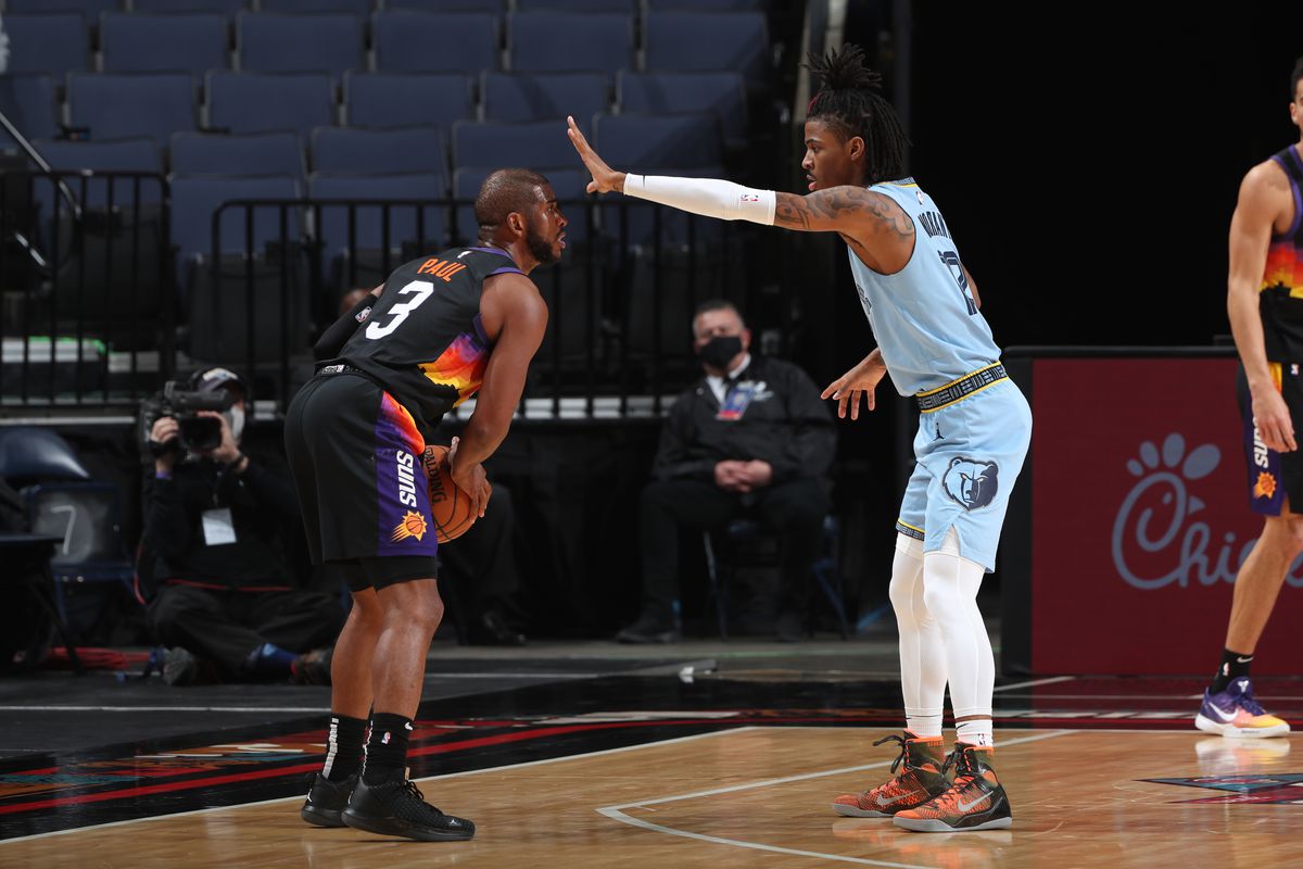 Ja Morant #12 of the Memphis Grizzlies plays defense during the game against Chris Paul #3 of the Phoenix Suns on February 20, 2021 at FedExForum in Memphis, Tennessee.&nbsp;