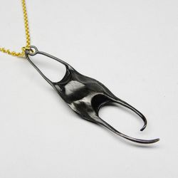 Large Skate Egg Case Necklace, <a href="http://www.hannahblount.com/collections/ruthie-b/products/large-skate-egg-case-necklace#">$198</a>
