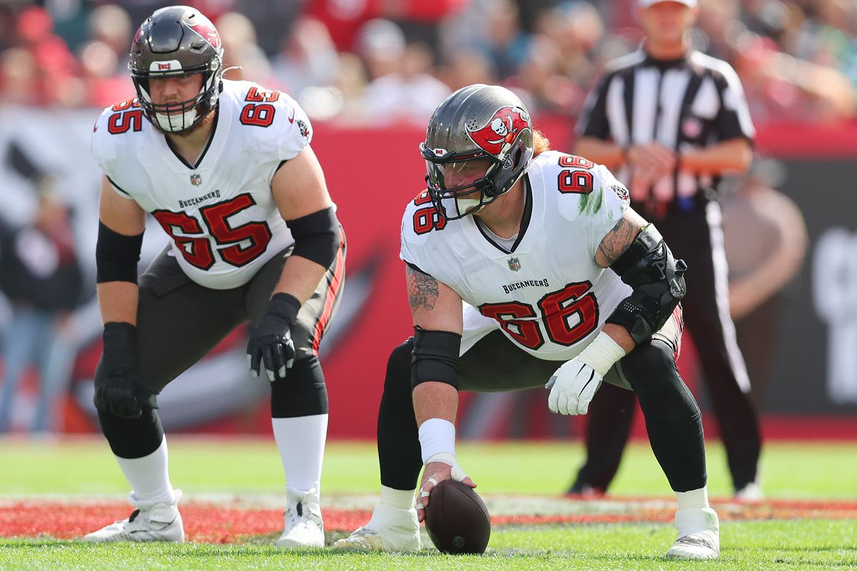 Alex Cappa #65 and Ryan Jensen #66 of the Tampa Bay Buccaneers in action against the Philadelphia Eagles in the first half of the NFC Wild Card Playoff game at Raymond James Stadium on January 16, 2022 in Tampa, Florida.