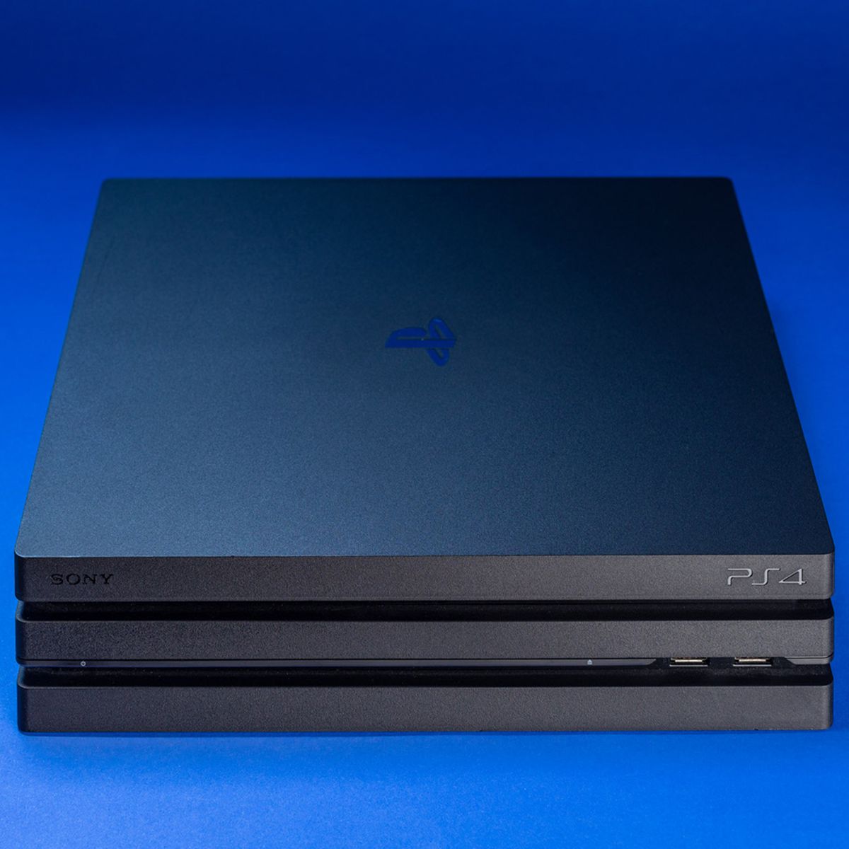 Sony PS4 Pro console on blue background