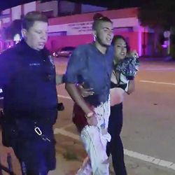 An injured man is escorted out of the Pulse nightclub after a shooting rampage, Sunday morning June 12, 2016, in Orlando, Fla. A gunman wielding an assault-type rifle and a handgun opened fire inside a crowded gay nightclub early Sunday, killing at least 50 people before dying in a gunfight with SWAT officers, police said. It was the deadliest mass shooting in American history. 