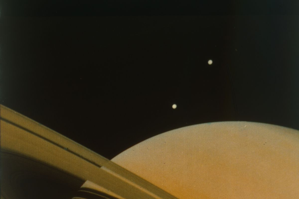 The Planet Saturn With Moons Tethys And Dione. Creator: Nasa.