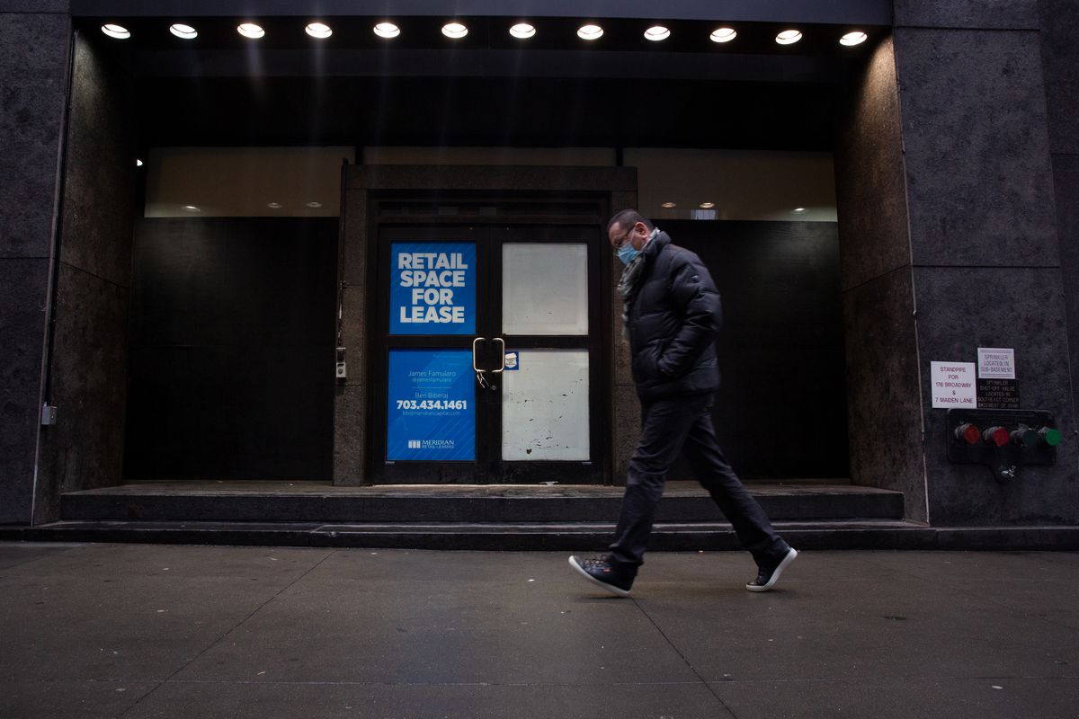 People walk by an empty storefront in Lower Manhattan, Jan. 5, 2022.