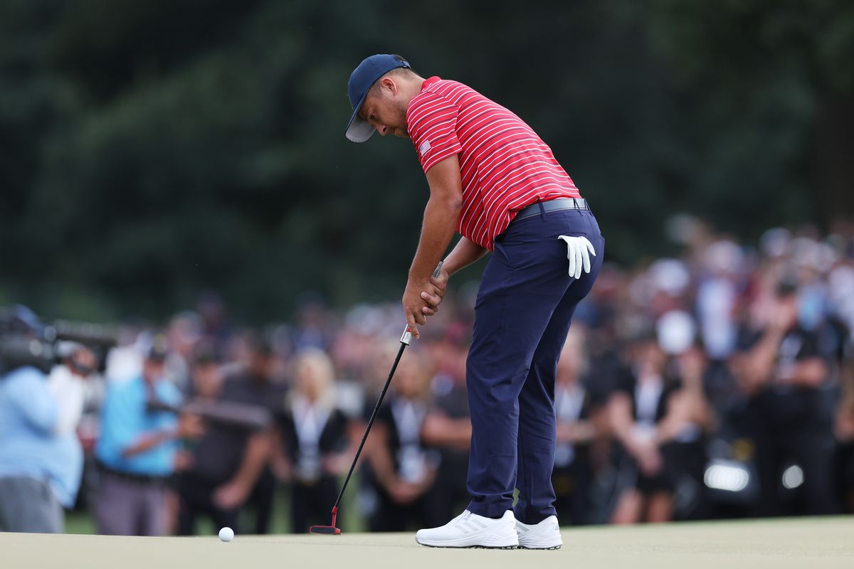 Xander Schauffele of the United States Team putts for the win on the 18th green during Sunday singles matches on day four of the 2022 Presidents Cup at Quail Hollow Country Club on September 25, 2022 in Charlotte, North Carolina.