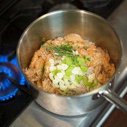 Dobkin sears off the shrimp shells before adding the aromatics: shallots, fennel, celery, and garlic.