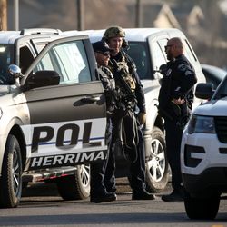 Law enforcement officers respond in the neighborhood east of Fashion Place Mall after a shooting at the mall in Murray on Sunday, Jan. 13, 2019.