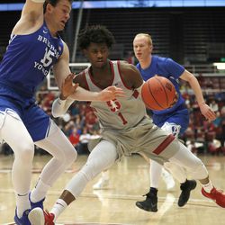 Stanford guard Daejon Davis (1) drives against BYU forward Payton Dastrup (15) during the first half of an NCAA college basketball game in the first round of the NIT on Wednesday, March 14, 2018, in Stanford, Calif. (AP Photo/ Tony Avelar)