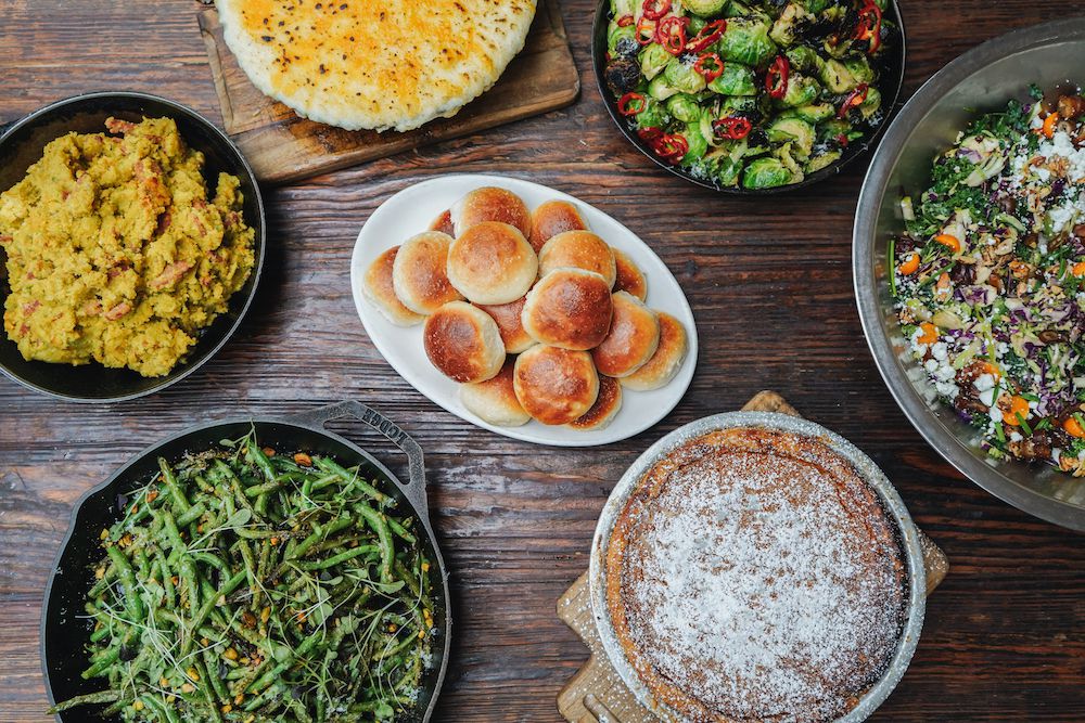 A spread of Thanksgiving sides on a wooden table.