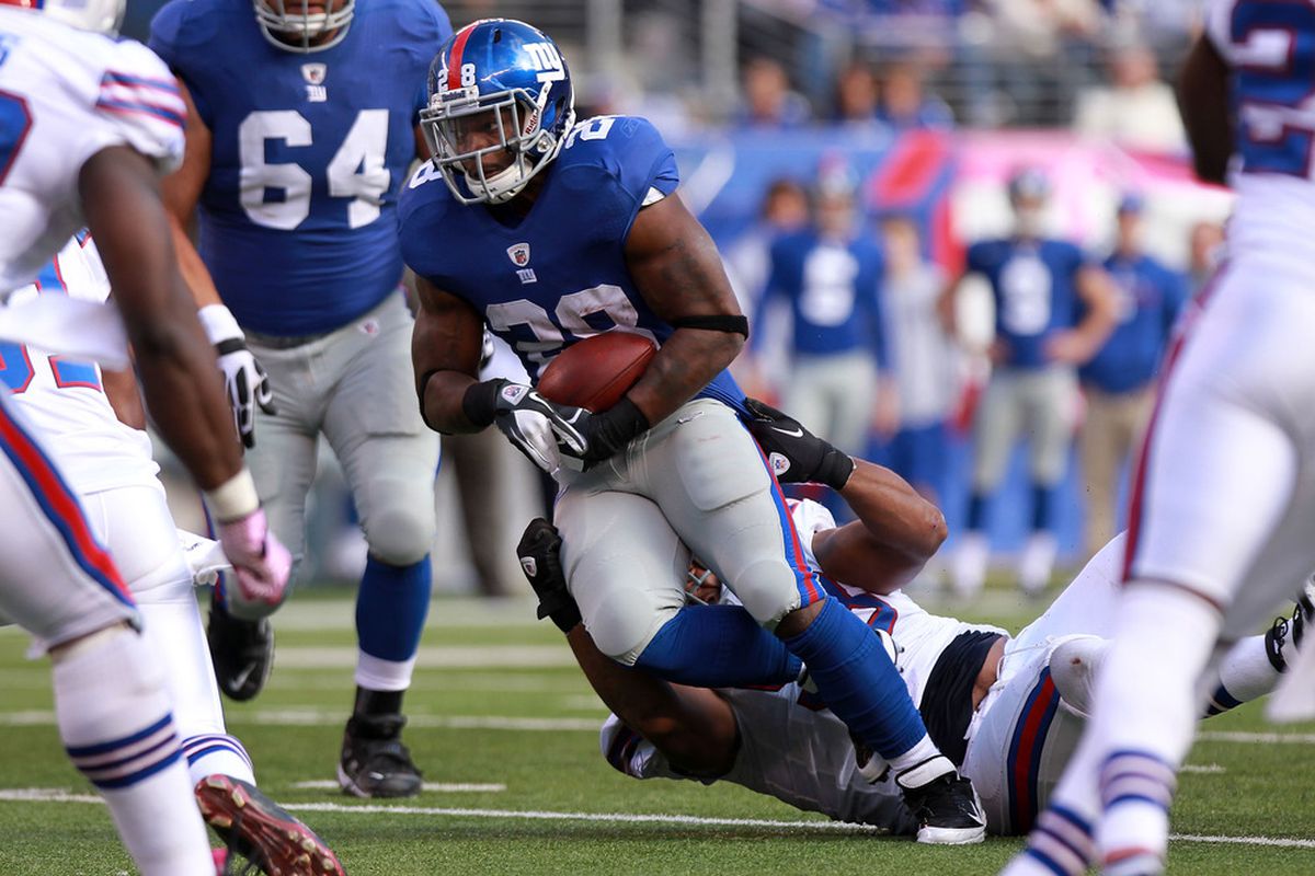 EAST RUTHERFORD, NJ - OCTOBER 16:  D.J. Ware #28 of the New York Giants rushes against the Buffalo Bills at MetLife Stadium on October 16, 2011 in East Rutherford, New Jersey.  (Photo by Nick Laham/Getty Images)