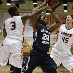 BYU's Anson Winder, center, is defended by Pepperdine's Jeremy Major, left and Jett Raines during the first half of an NCAA college basketball game Thursday, Feb. 5, 2015, in Malibu, Calif.