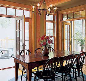 <p>Transoms above the dining room's French doors and windows bring in more light and add height to the 10-foot ceilings.</p>