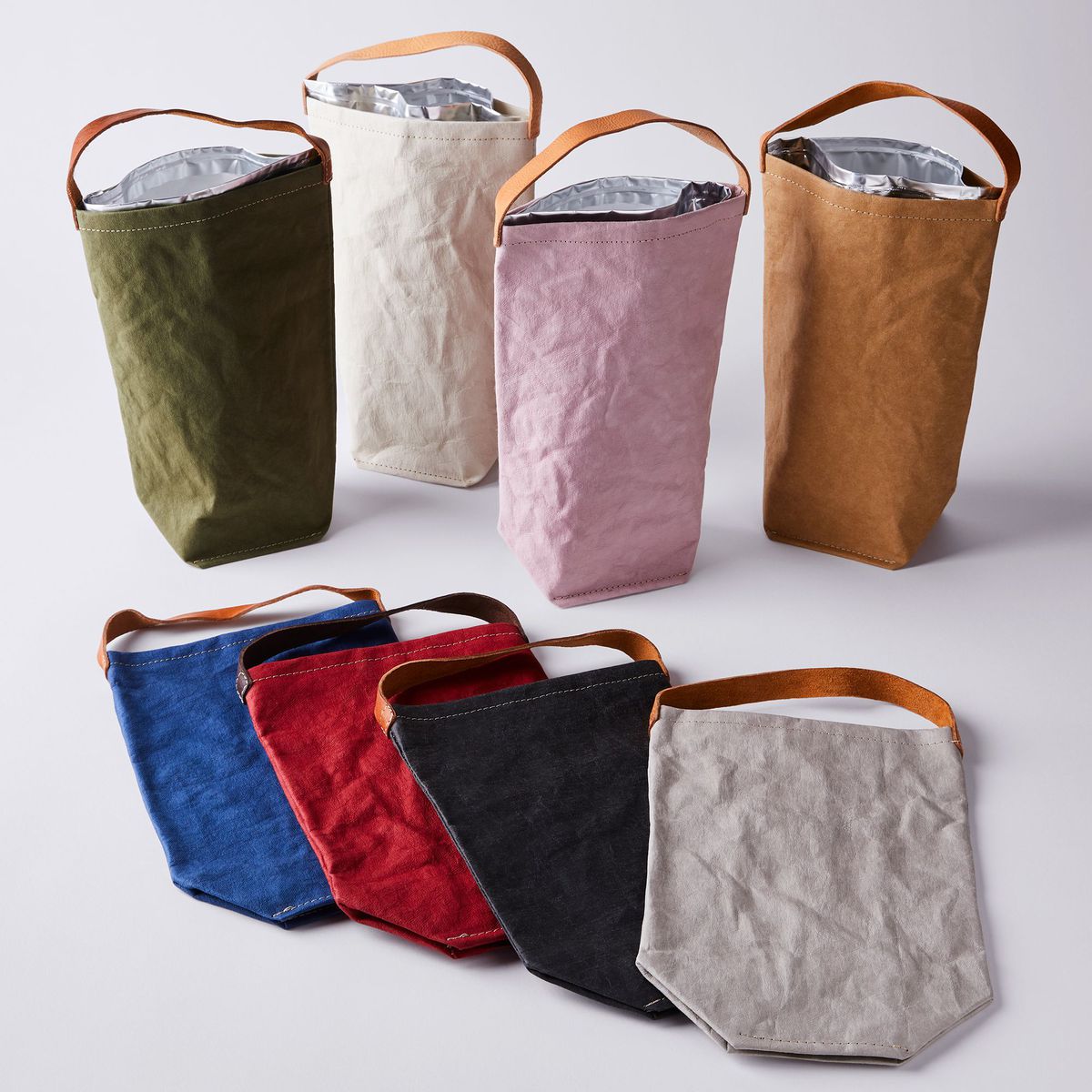 An assortment of combination wine bags and coolers in various colors