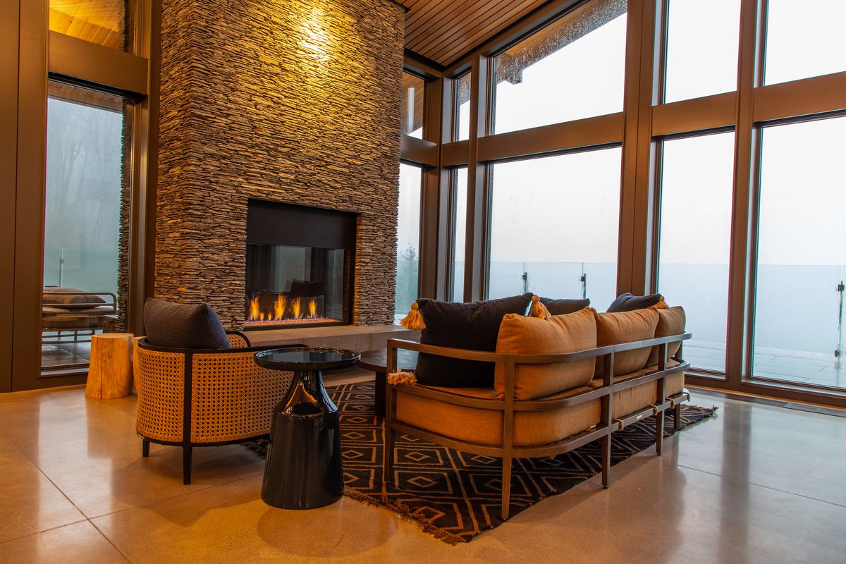 Another fireplace at Amaterra, surrounded by mid-century couches and armchairs