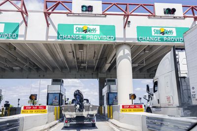 Fort Lauderdale Florida, I-75 interstate highway toll booth with car and boat paying toll, Sun Pass change provided