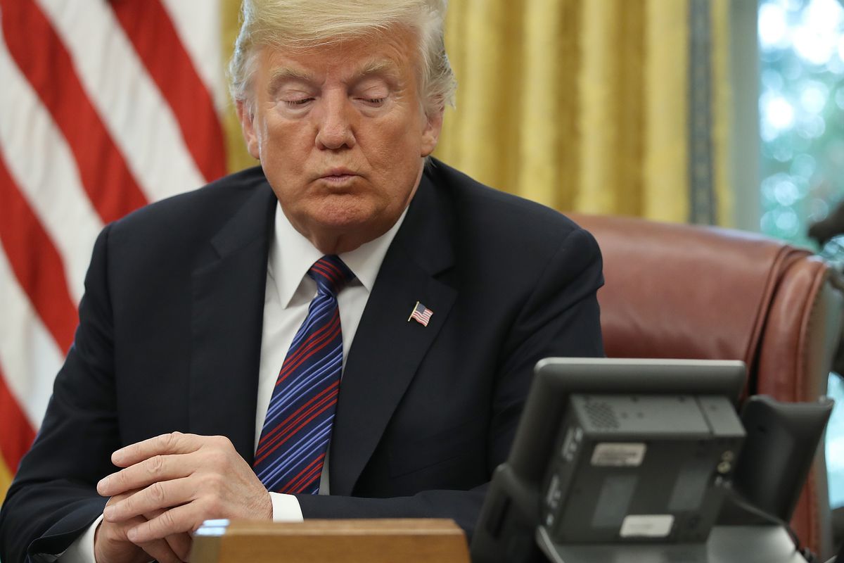 President Donald Trump speaks on the phone from the Oval Office in August 2018.