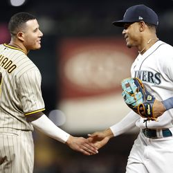  SEATTLE, WASHINGTON - SEPTEMBER 13: Manny Machado #13 of the San Diego Padres and Julio Rodriguez #44 of the Seattle Mariners greet one another during the ninth inning at T-Mobile Park on September 13, 2022 in Seattle, Washington.