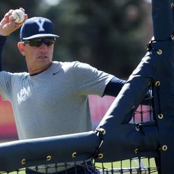 BYU baseball coach Mike Littlewood throws a pitch during practice at the Larry H. Miller Field in Provo on Thursday, April 18, 2013.