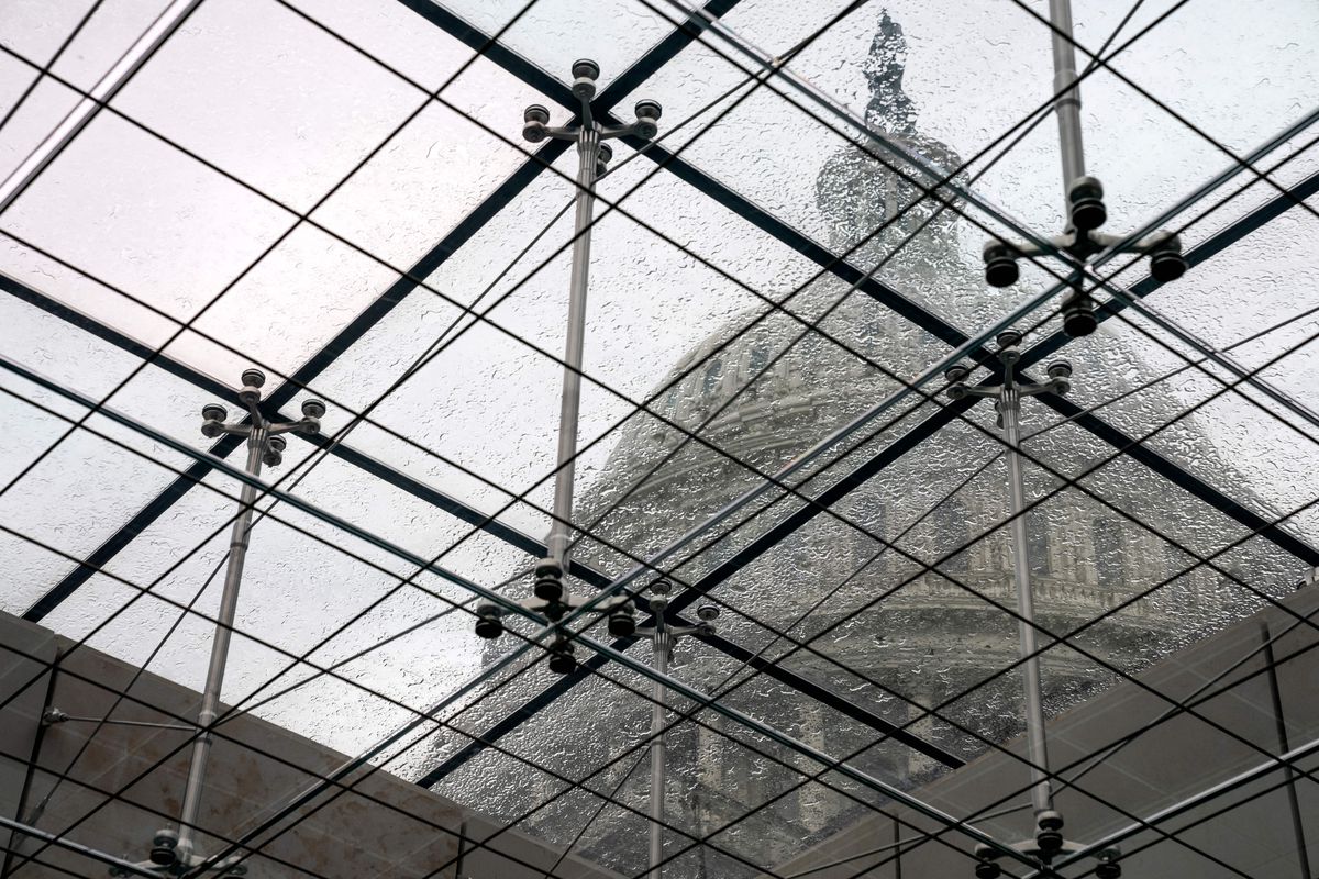 The Capitol dome is seen through scaffolding. 