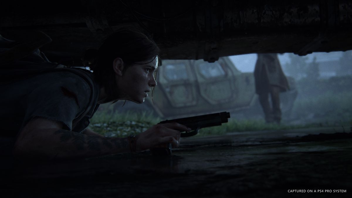 Ellie hides under a car in The Last of Us Part 2