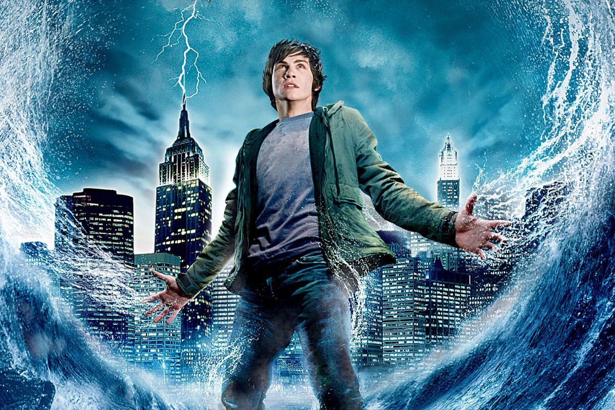 Official artwork shows logan lerman as percy Jackson with a city behind him