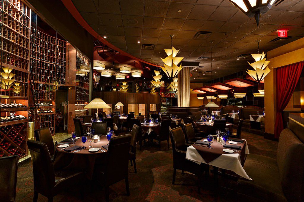 Perry’s Steakhouse &amp; Grille has an art deco decor with leather seating and dark wood tables and furniture. 