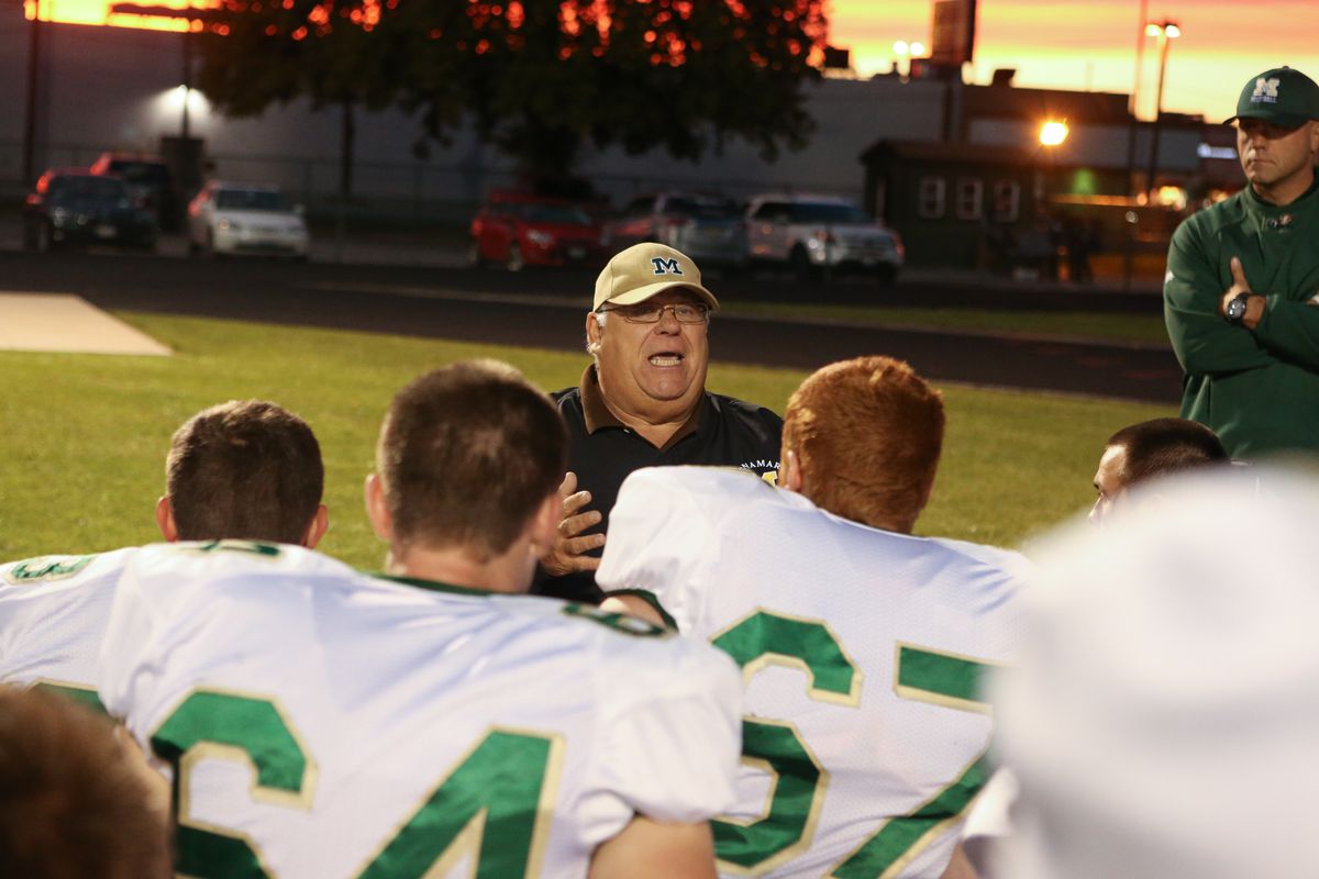Bishop McNamara’s head coach Rich Zinanni talks to his team before they take the field against Fenwick in 2013.