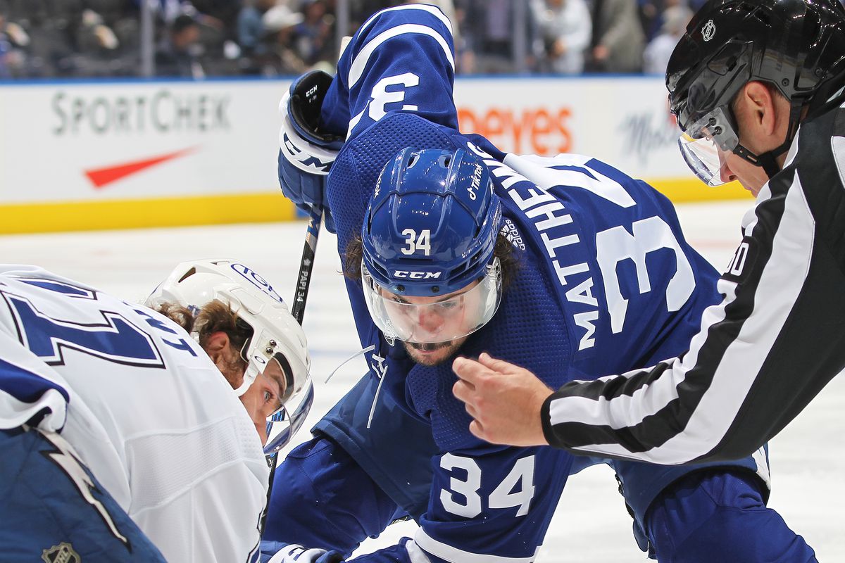 Brayden Point #21 of the Tampa Bay Lightning takes a faceoff against Auston Matthews #34 of the Toronto Maple Leafs during Game Seven of the First Round of the 2022 Stanley Cup Playoffs at Scotiabank Arena on May 14, 2022 in Toronto, Ontario, Canada.