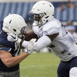 Wide Receiver 	Chayce Bolli, left, is grabbed by Linebacker Francis Bernard at a BYU football practice in Provo on Thursday, August 10, 2017.