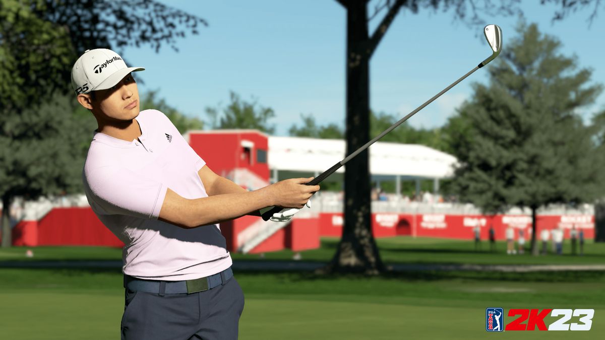 Collin Morikawa, wearing a pastel pink polo and dark slacks, watches a shot fly in PGA Tour 2K23