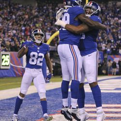 New York Giants tight end Jerell Adams (89) celebrates with offensive tackle Bobby Hart (68) and wide receiver Roger Lewis (82) after scoring a touchdown against the Cincinnati Bengals during the first quarter of an NFL football game, Monday, Nov. 14, 2016, in East Rutherford, N.J. 